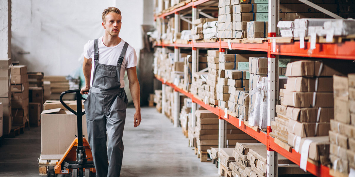 Young man working at a warehouse with boxes