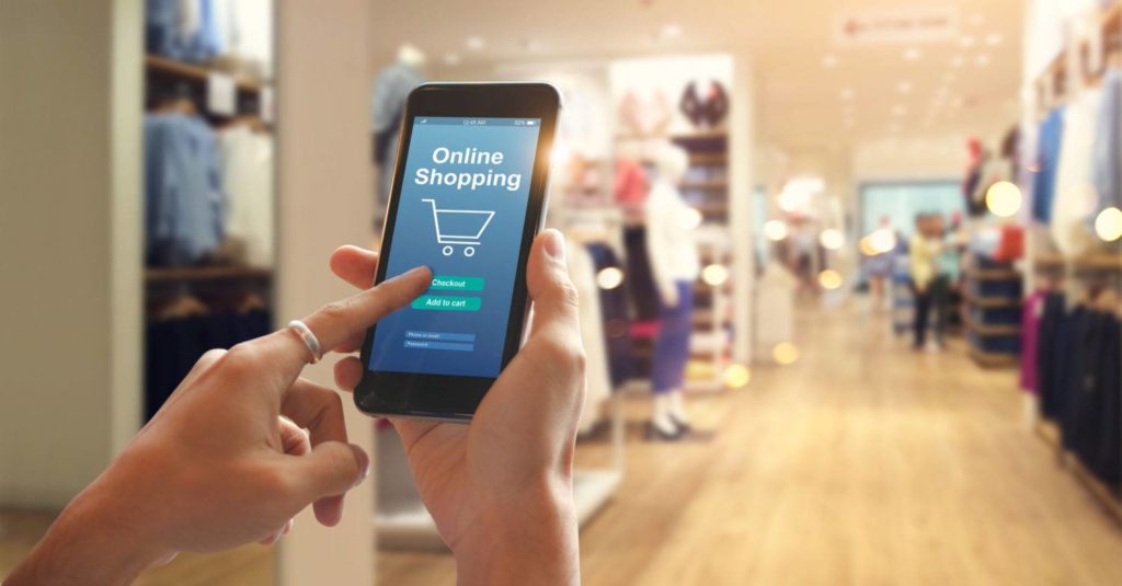 Smart phone online shopping in woman hand. Network connection on mobile screen. Payments online. Shopping mall department store background