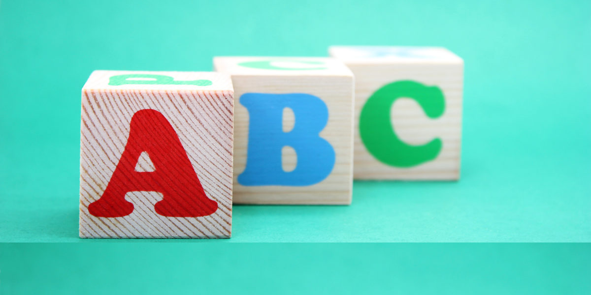 English ABC letters on wooden toy blocks. letters of the English alphabet. Learn foreign languages. English for beginners. Copy space.